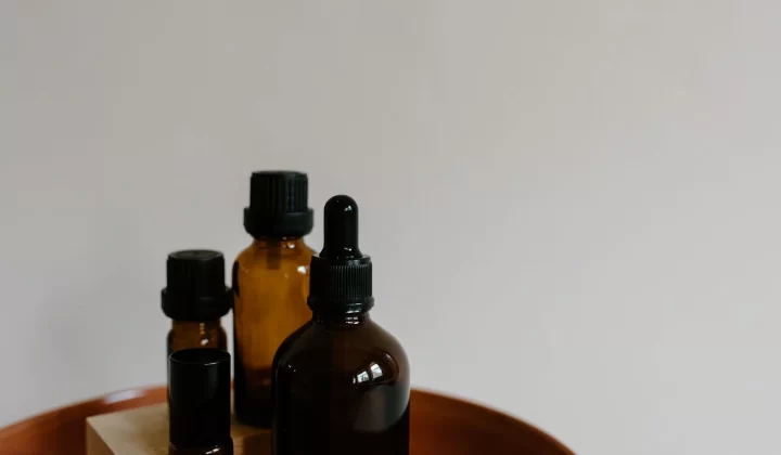 木托盘上摆放的琥珀色精油滴管瓶