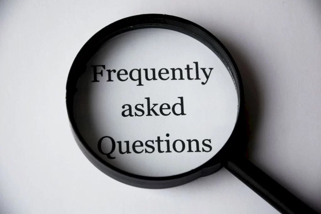 放大镜聚焦在"Frequently Asked Questions"文字上特写