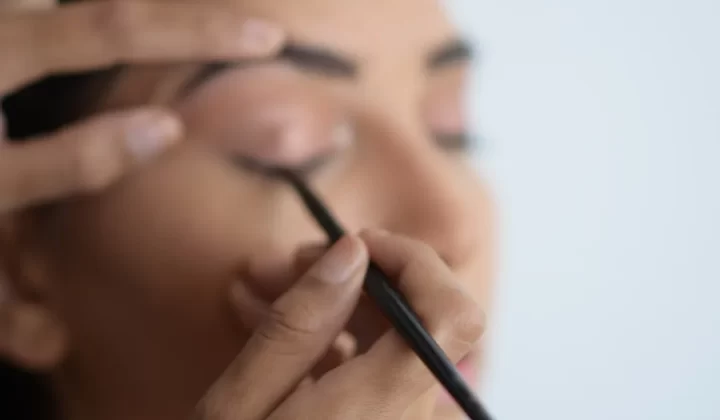 person holding black pen in close up photography