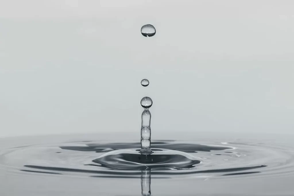 a drop of water falling into a body of water