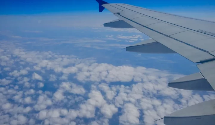 the wing of an airplane flying above the clouds