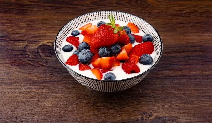 strawberry and blackberries on top of brown table