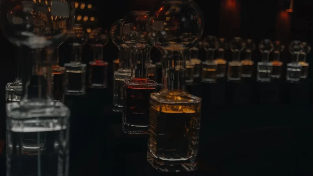 Row of glass bottles filled with colored liquids