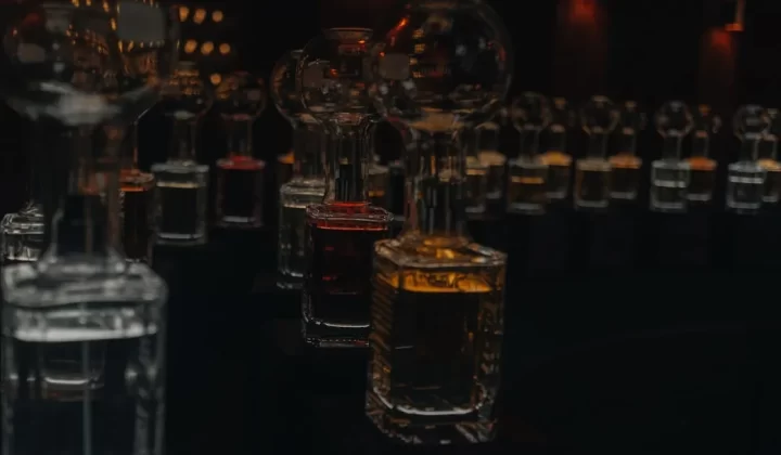 Row of glass bottles filled with colored liquids