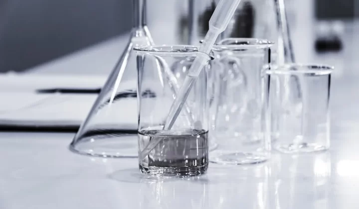 three clear beakers placed on tabletop