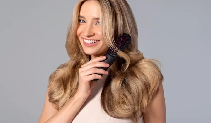 a woman holding a hair brush in her hand