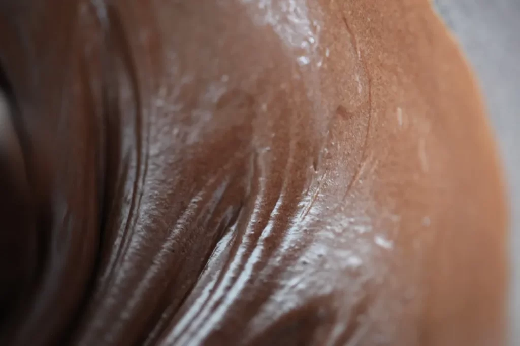 Close-up of wet, dark skin with white suds