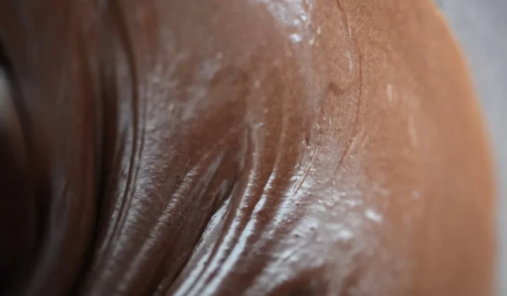 Close-up of wet, dark skin with white suds