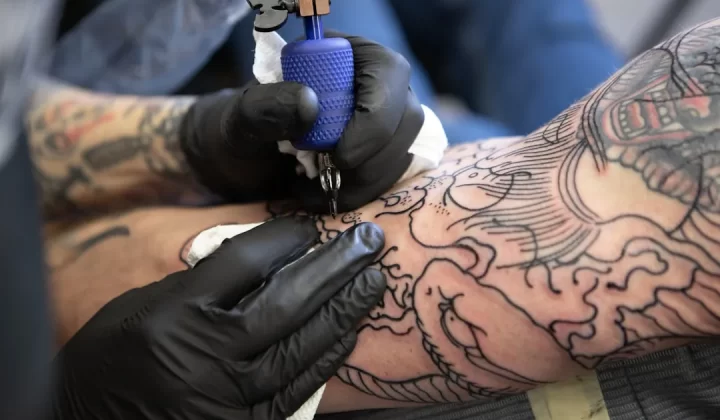 person with tattoo on right arm