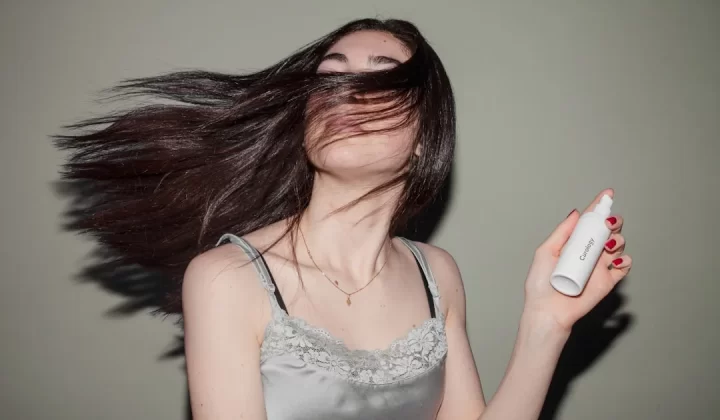 woman holding spray bottle