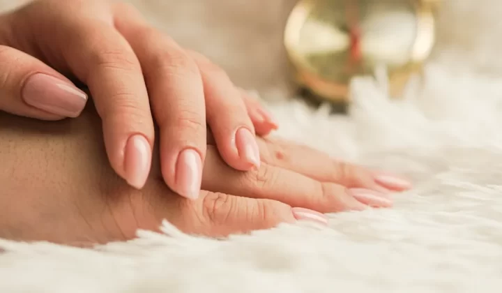 persons hand on white textile