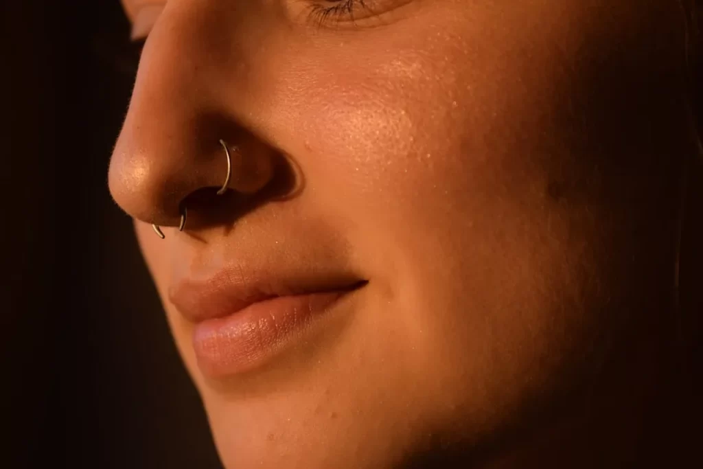 a close up of a woman with a nose piercing