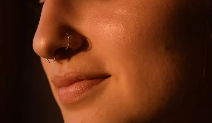 a close up of a woman with a nose piercing