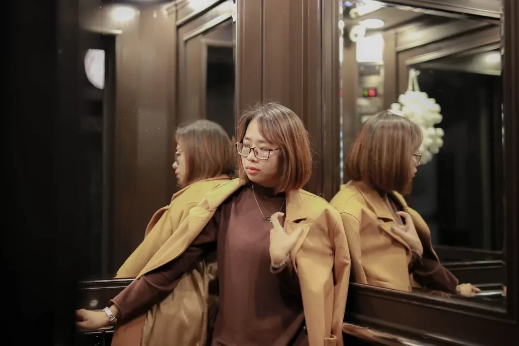 woman in brown coat standing beside woman in brown coat