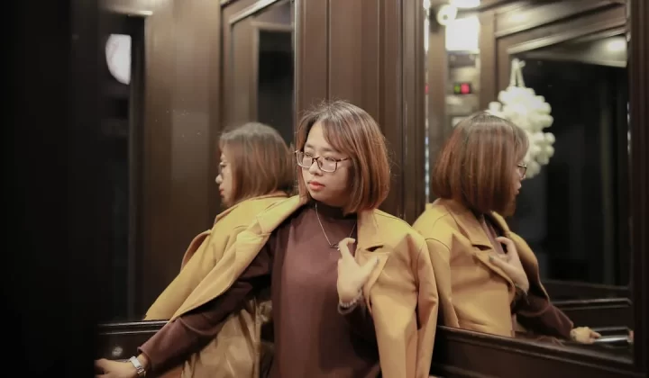 woman in brown coat standing beside woman in brown coat