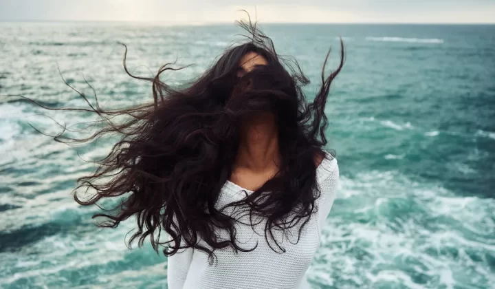 woman standing near body of water during daytime