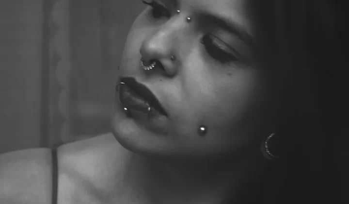 a woman with piercings on her nose and nose ring