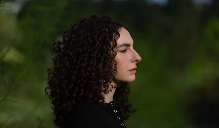 a close up of a person with curly hair