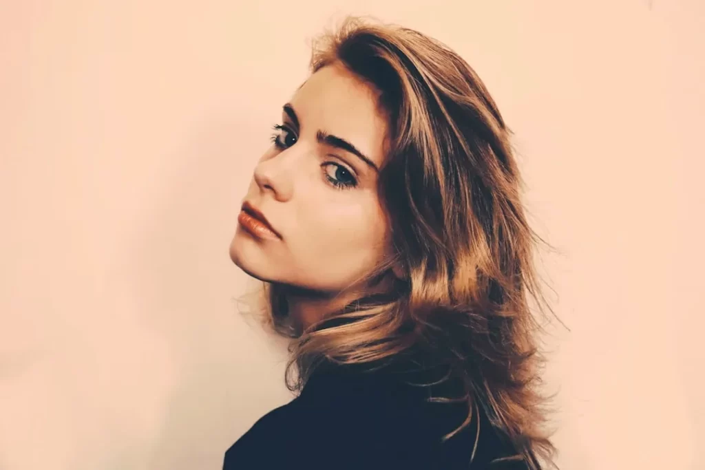 a woman with long hair and a black shirt
