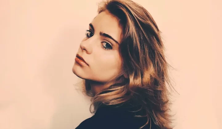 a woman with long hair and a black shirt