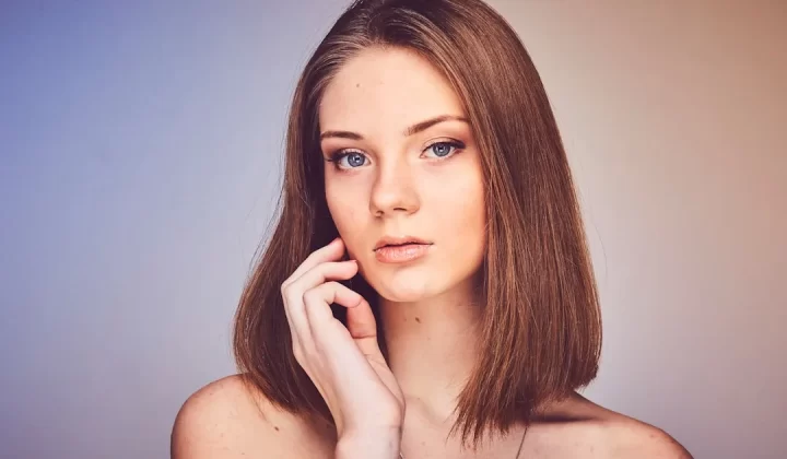 woman with her hand on cheek
