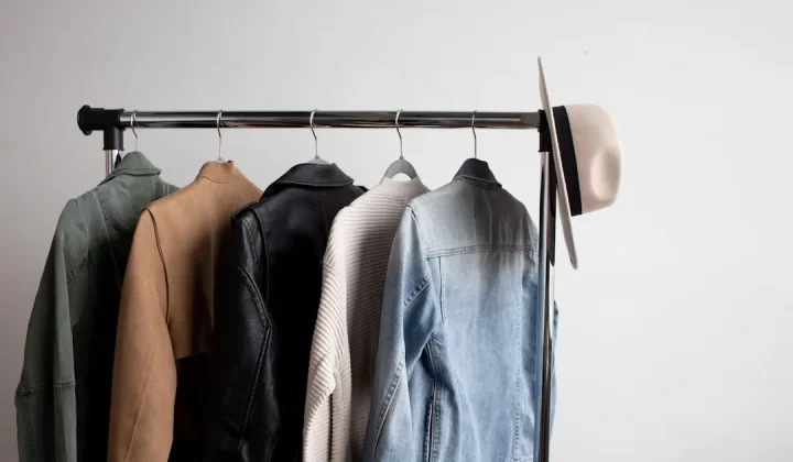 one cowboy hat and five jackets hanged on clothes rack