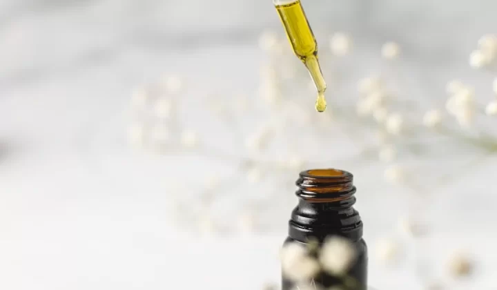 clear glass bottle with yellow lid