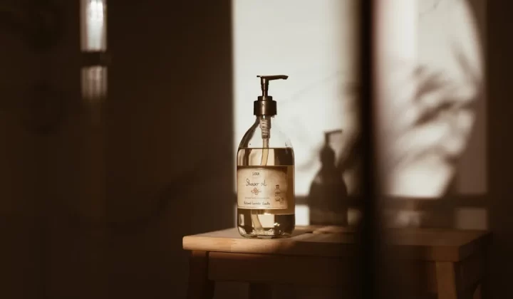 a bottle of soap sitting on top of a wooden table