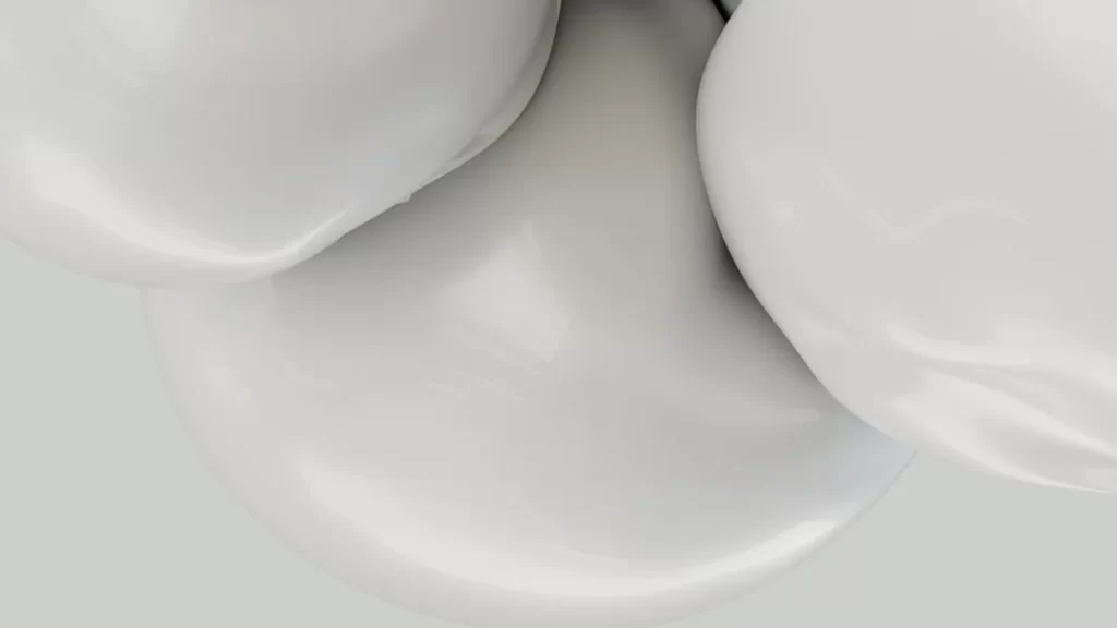 a close up of a white object with a gray background