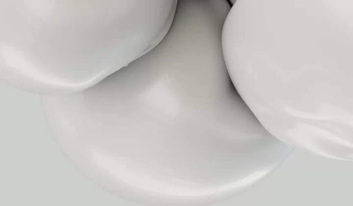 a close up of a white object with a gray background