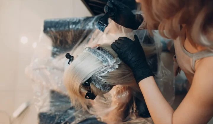 woman in black shirt lying on white textile
