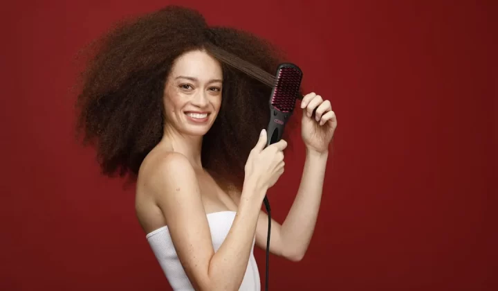 a woman holding a hair brush in her hand