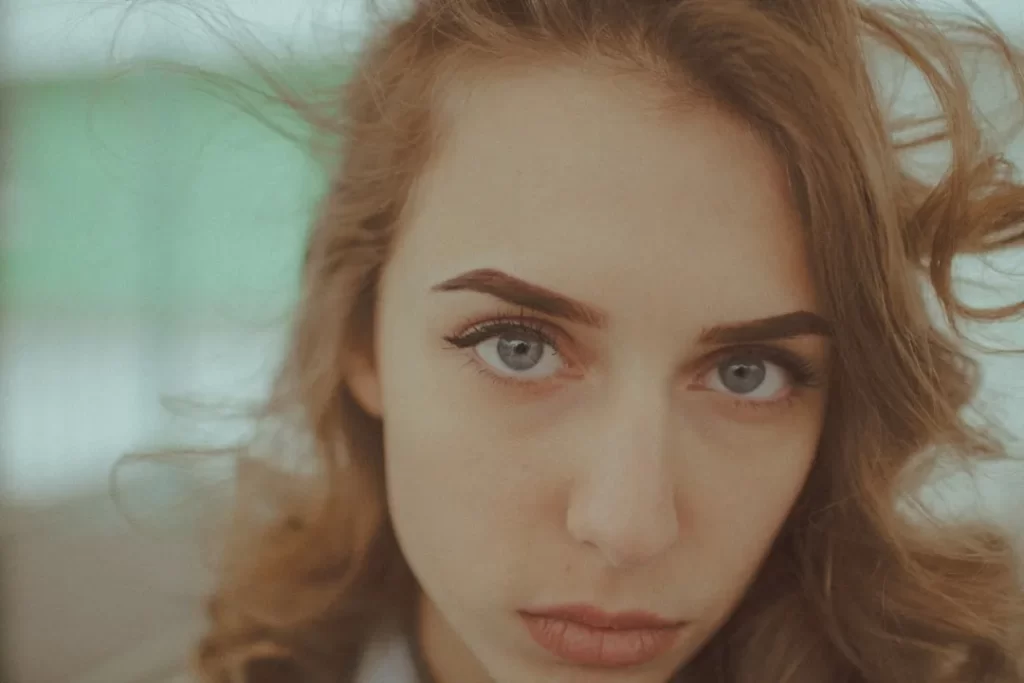Young woman with blue eyes looking directly at the camera.