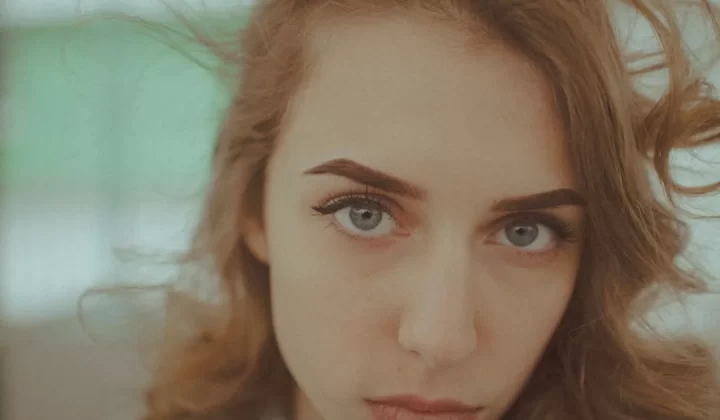 Young woman with blue eyes looking directly at the camera.