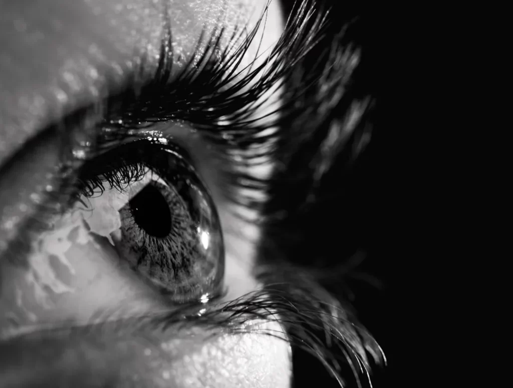 a close up of a person's eye with water on it