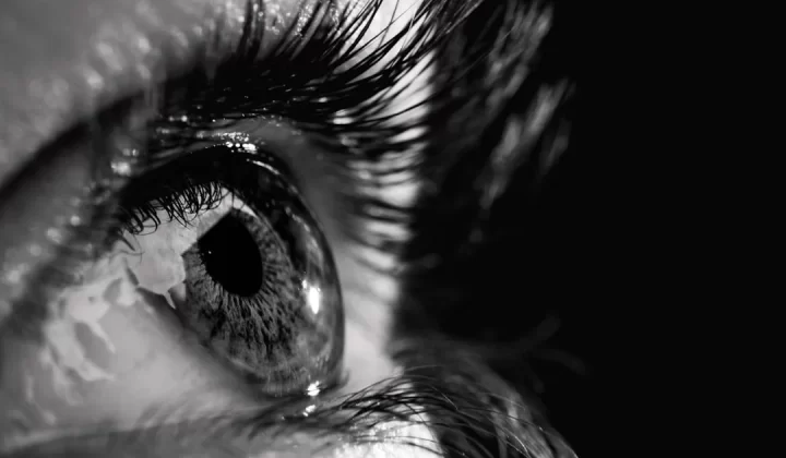 a close up of a person's eye with water on it