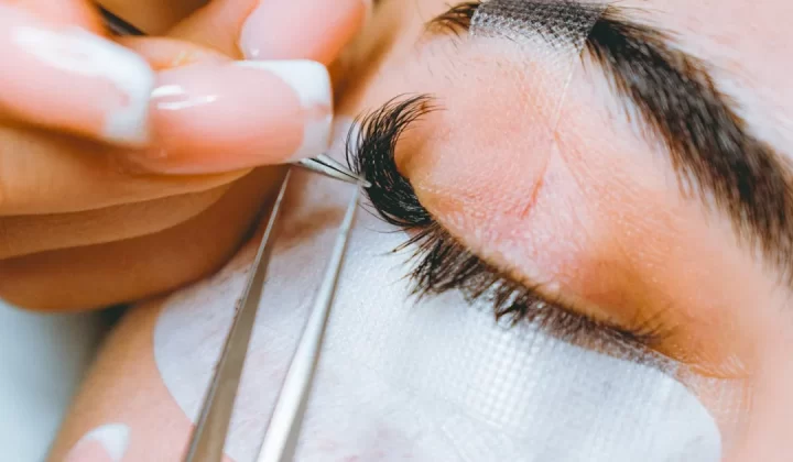 A close up of a person cutting a persons eye