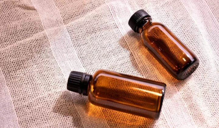 two small brown bottles sitting on top of a table