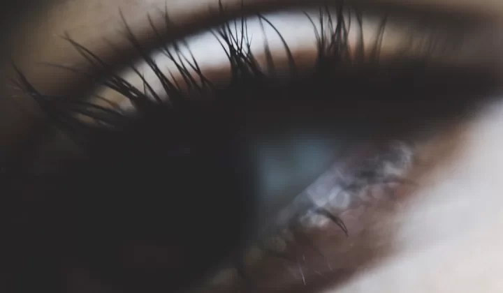 a close up of a person's eye with long eyelashes