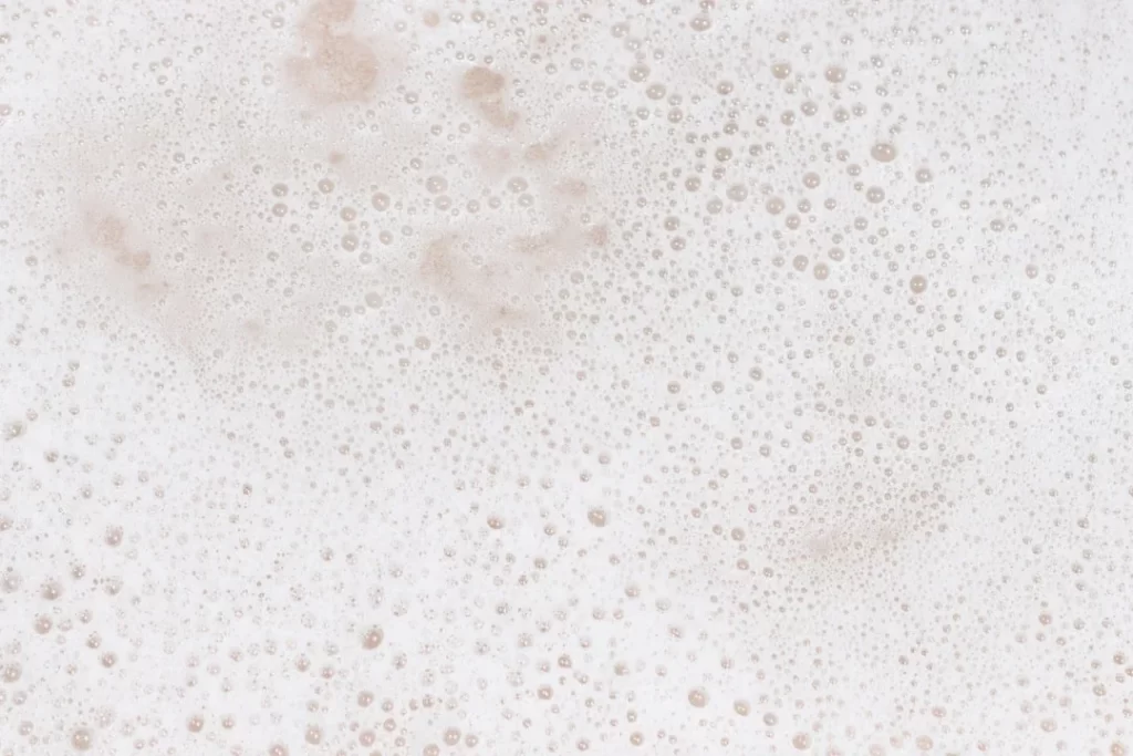 a close up of a foamy surface with bubbles