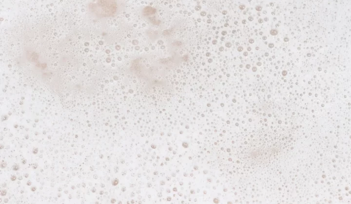 a close up of a foamy surface with bubbles