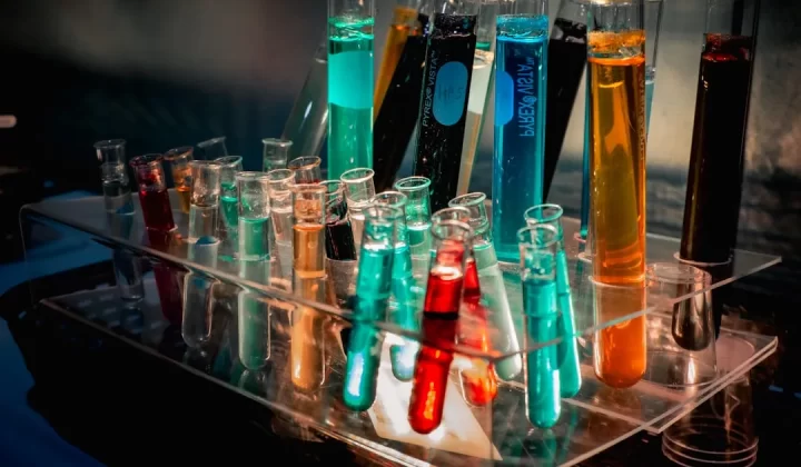 a bunch of test tubes filled with different colored liquids