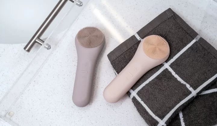 a hair brush and a towel on a bathroom floor