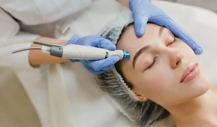 a woman getting a facial peel from a doctor