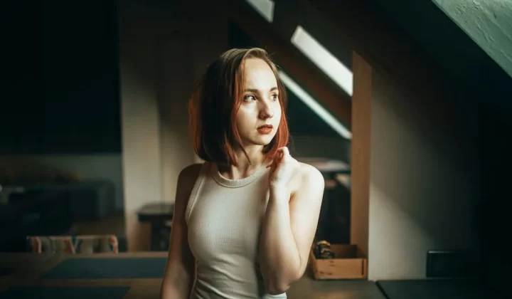 Young woman with auburn hair indoors