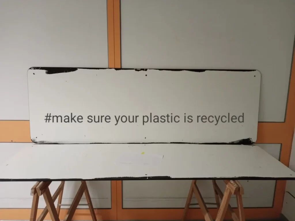 a sign that says make sure your plastic is recycled