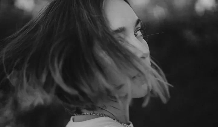 a black and white photo of a person with long hair