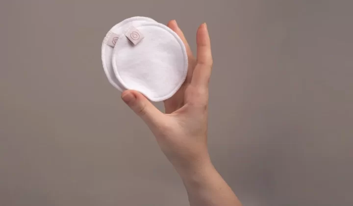 a hand holding a white ball