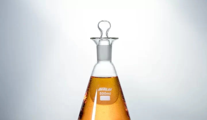 clear glass bottle with brown liquid