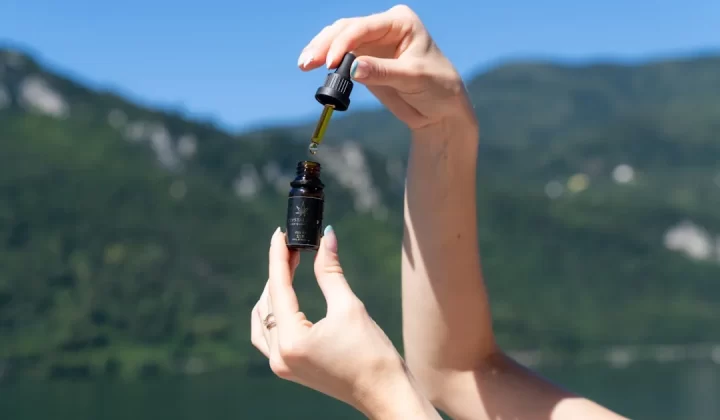 A person is dropping liquid from a bottle.